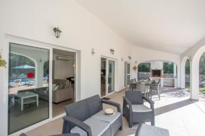 a living room with chairs and a couch and a table at Villa Macarella by Sonne Villas in Cala Galdana