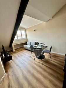 a living room with a couch and a table and chairs at Casa Valprato in Turin