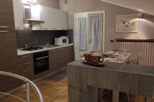 a kitchen with a counter top and a stove top oven at B&b La casa di Cesy in Castrezatto