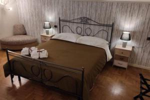 a bedroom with a large bed and a chair at B&b La casa di Cesy in Castrezatto