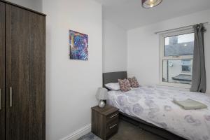 a bedroom with a bed and a window at Beautiful Family Home in Blackpool for you in Blackpool
