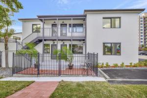 a white house with a wrought iron gate at Studio Right off Las Olas - Steps to FTL Beach 1C in Fort Lauderdale