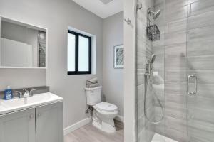 a bathroom with a shower and a toilet and a sink at Studio Right off Las Olas - Steps to FTL Beach 1C in Fort Lauderdale