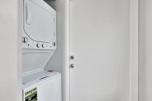 an open door to a refrigerator with a microwave at Condo Right off Las Olas Steps to FTL Beach 1A in Fort Lauderdale