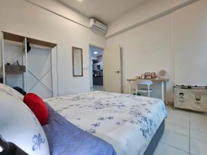 a bedroom with a bed with a blue and white blanket at NEW Sunway Greenfield Home 2-6pax 5mins to Sunway Pyramid in Petaling Jaya