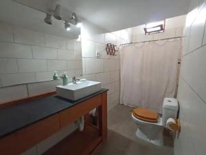 a bathroom with a sink and a toilet and a sink at La Casona de Aime, Habitaciones privadas con Desayuno in Punta del Este