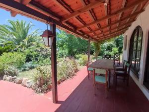a patio with a table and chairs on a deck at La Casona de Aime, Habitaciones privadas con Desayuno in Punta del Este