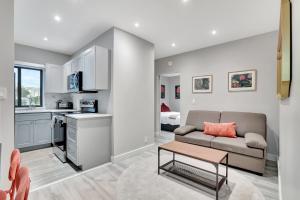 a living room with a couch and a kitchen at Condo Right off Las Olas - Steps to FTL Beach 2A in Fort Lauderdale