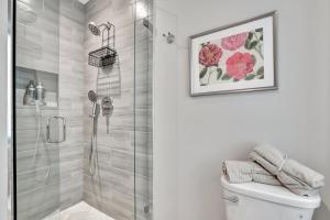 a bathroom with a shower stall and a toilet at 2 Condo Combo - Walk to Beach Off Las Olas 1AB in Fort Lauderdale +75 photos