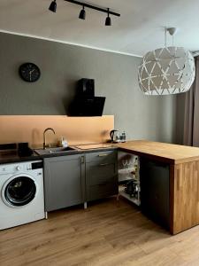 a kitchen with a sink and a washing machine at Grey studio in Maardu in Maardu
