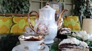a tea pot and a cup of coffee and a cake at In House in Tbilisi City