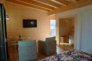 a room with a bed and a table and a television at Agriturismo La Masseria - La casa tra gli alberi in Cugnoli
