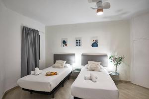バルセロナにあるBBarcelona Encants Flatの白い壁の客室内のベッド2台
