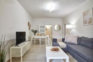 a living room with a couch and a table at BBarcelona Encants Flat in Barcelona