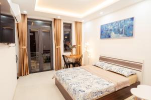 una habitación de hotel con una cama y una mesa con una mesa en The Sophia Apartment - Thao Dien Central en Ho Chi Minh