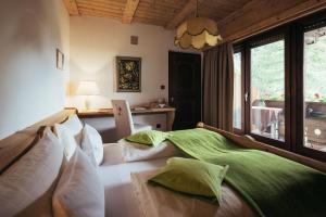 a bedroom with a large bed with white pillows at Haus Elisabeth in Santa Gertrude nella Val d'Ultimo