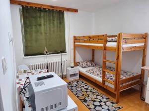 a small room with two bunk beds and a microwave at Privat Tatry Dreams in Nová Lesná