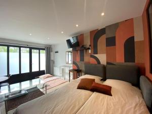 a bedroom with a large bed with a wall with a mural at Le nuage des balmes in Caluire-et-Cuire