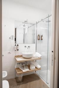 a bathroom with a sink and a shower at Domus Vitra in Rome