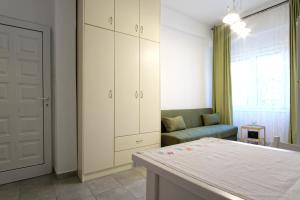 a living room with a couch and a white cabinet at Andriana's studio in Parga