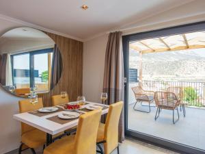 a dining room with a table and chairs and a balcony at Asfiya Loft Apartments in Kas