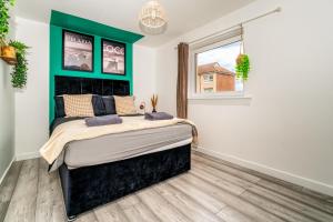 a bedroom with a large bed in a room at A Gem in Greenock - Sleeps 8 in Greenock
