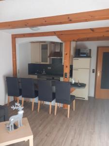 a kitchen and dining room with a table and chairs at Haus Heidelberg in Feldberg