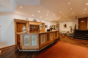 a large room with a bar and a staircase at Sonnenhotel Hoher Hahn in Schwarzenberg