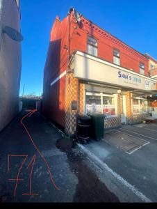 a store front with a building and a street at Quite Broad Rest 5 in Longford