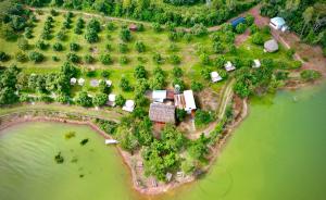 an aerial view of an island in the water at The Secret Garden Camping - Hồ Trị An 