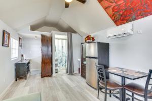 a kitchen and dining room with a table and a refrigerator at Lakefront Panama City Studio with Hot Tub Access in Panama City