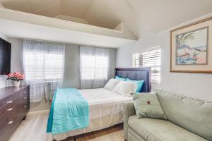 a bedroom with a bed and a couch at Lakefront Panama City Studio with Hot Tub Access in Panama City