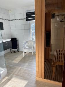 a room with a kitchen with a table and a chair at Villa Louise in Stavelot