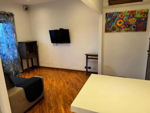 a living room with a couch and a tv on the wall at Appartamento Roma montesacro in Rome