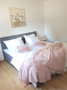 a bedroom with a bed with a blanket on it at Apartments Habek 2 in Vrboska