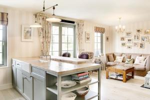 a kitchen with a sink and a living room at Lough Erne Resort Villa in Ballycassidy +11 photos