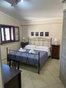 a bedroom with a bed and a table and a window at Ruben holiday in Palinuro