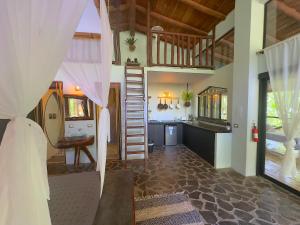 a room with a kitchen and a staircase in a house at Canaima Chill House in Santa Teresa Beach