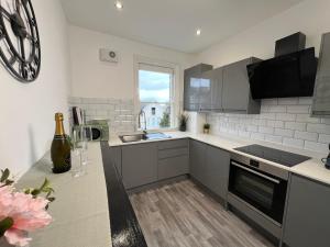 a kitchen with a sink and a counter top at Seaside Apartment close to beach, town, station in Broadstairs