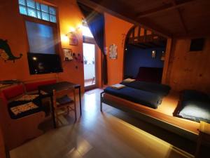 a bedroom with a bed and a tv and a table at High Sky Apartment in Budapest