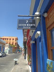 a sign for seven nights hospital on the side of a building at Hostal Seven Nights Cartagena in Cartagena de Indias