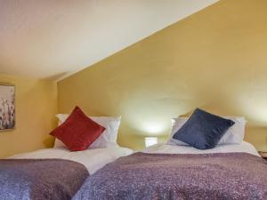 two beds sitting next to each other in a room at Cherry Cottage in Ipswich