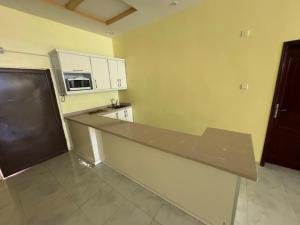 a kitchen with a counter top and a microwave at شاليه مجهز بالكامل مسبح وملعب و حديقه هادئه بضباء in Ḑubā