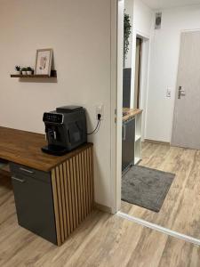 a kitchen with a television on top of a counter at Isaak Appartement Harmonie in Küssaberg