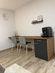 a room with a desk with a microwave and acomputer at Isaak Appartement Harmonie in Küssaberg +18 photos