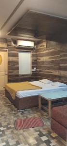 a bedroom with a bed and a white screen at PARK RESORT MATHERAN in Matheran