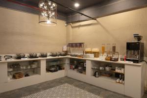 a kitchen with a counter with food on it at OAKTREE HOTEL in Morbi