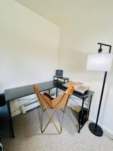 een bureau met een stoel en een bureau met een laptop bij Carriage Hill Apartment #11 in Whitewater