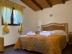 Postel nebo postele na pokoji v ubytování B&B Agriturismo 'A Cunziria
