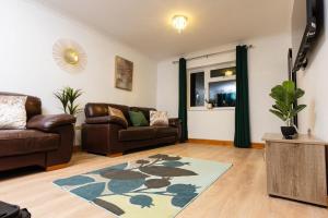 a living room with a couch and a rug at Sweet Dreams in Peterborough